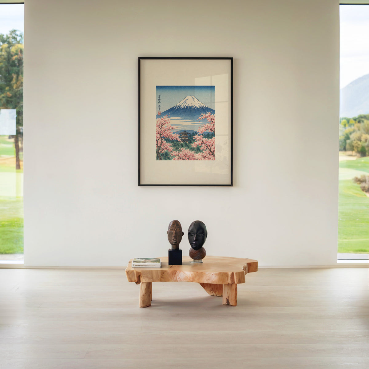 Mount Fuji with pagoda in spring print in a black frame above a live-edge wood coffee table between garden windows