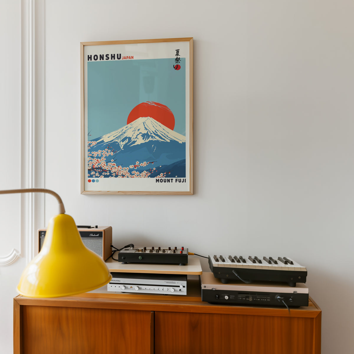 Mount Fuji red sun sakura print in an oak frame above a teak sideboard with vintage hi-fi