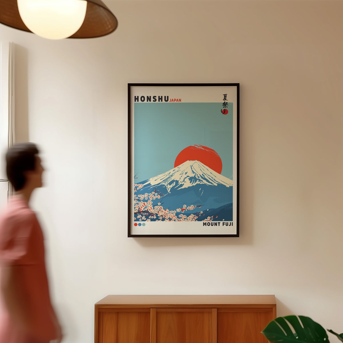 Mount Fuji red sun sakura print in a black frame in a hallway under a rattan pendant