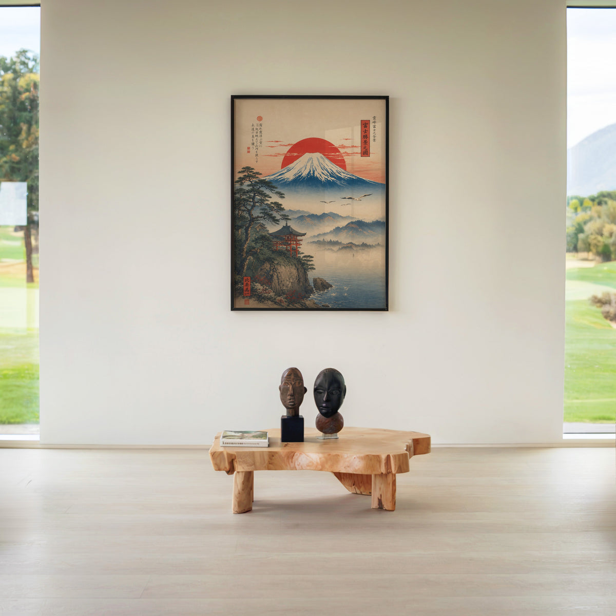 Mount Fuji sunrise with cliff shrine print in a black frame above a live-edge wood coffee table between garden windows