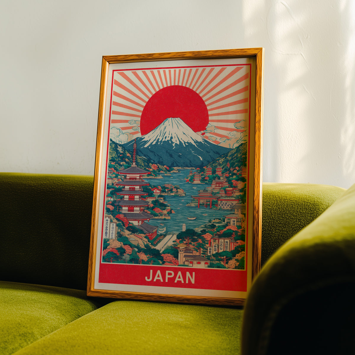 Mount Fuji sunburst lake print in an oak frame propped on a green velvet sofa