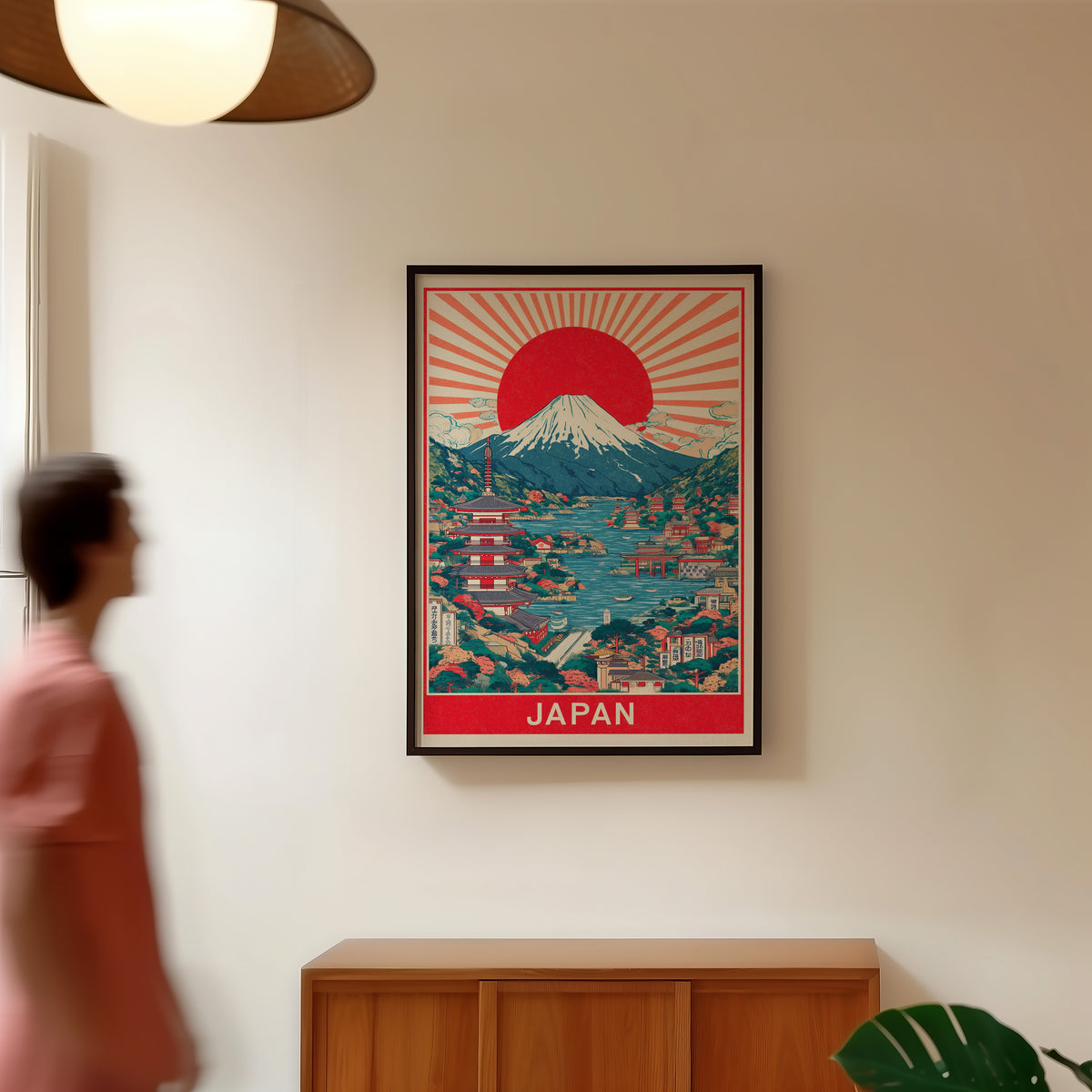 Mount Fuji sunburst lake print in a black frame in a hallway under a rattan pendant