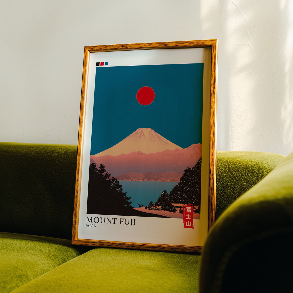 Minimalist Fuji teal sky print in an oak frame propped on a green velvet sofa