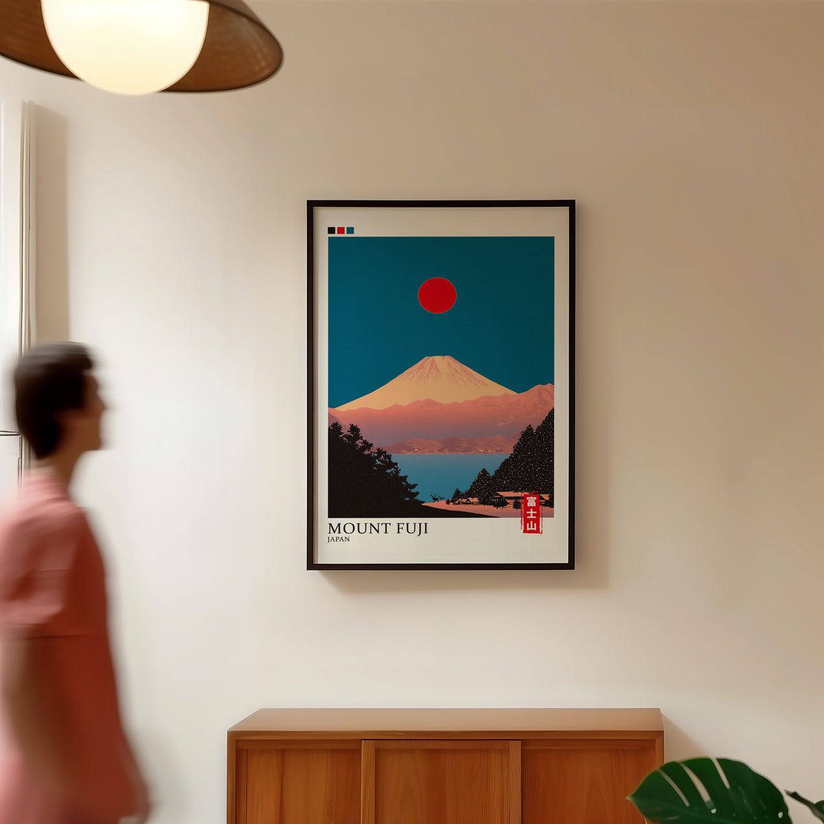 Minimalist Fuji teal sky print in a black frame in a hallway under a rattan pendant