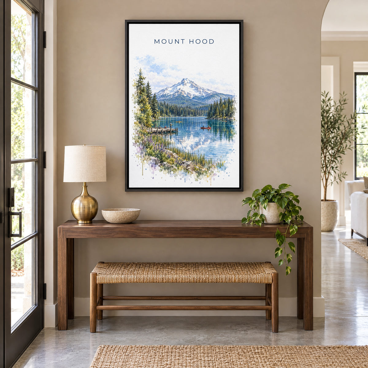 Mount Hood watercolor print as a black floater canvas above a walnut console and woven bench in an entryway