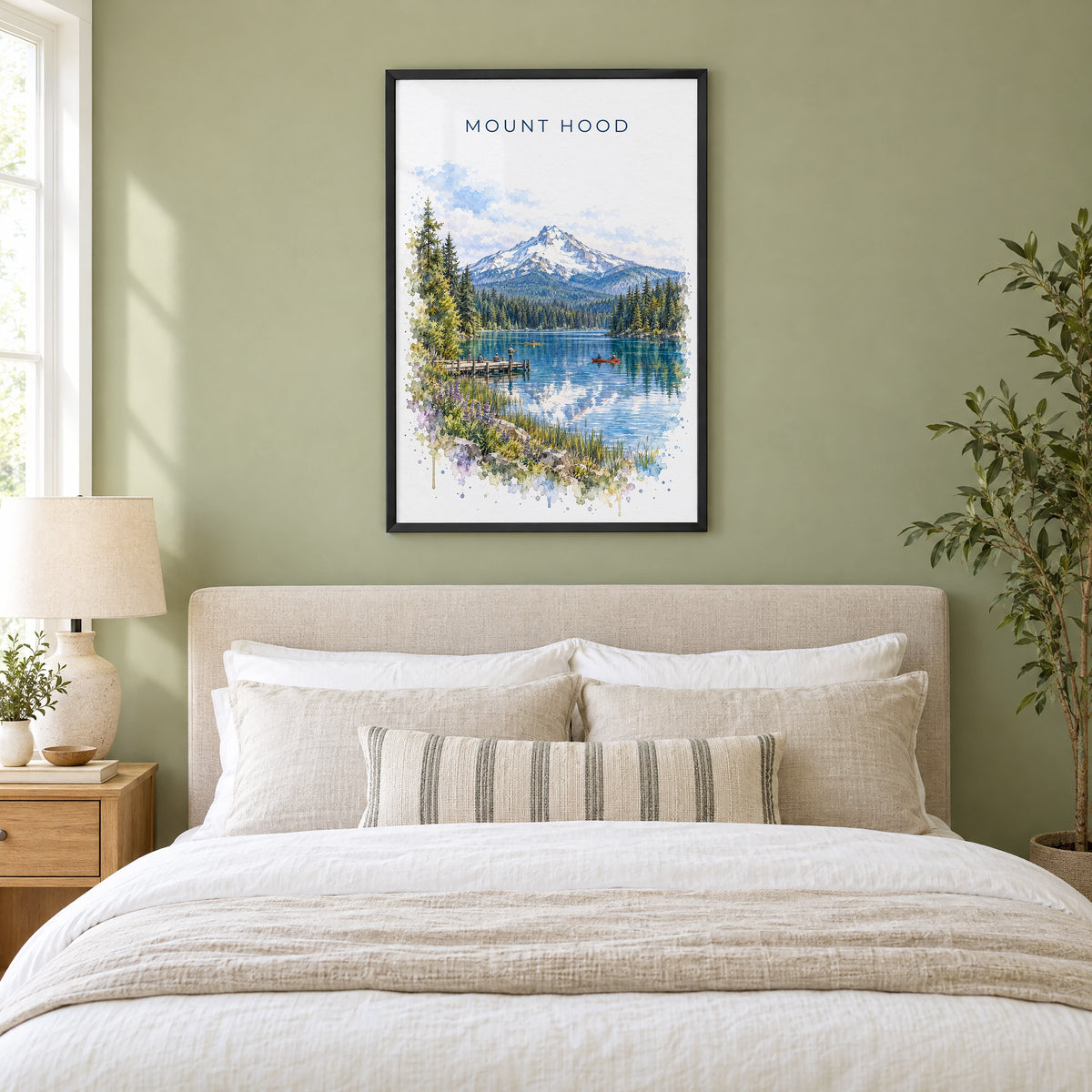 Mount Hood watercolor print in a black frame above an upholstered headboard in a sage green bedroom