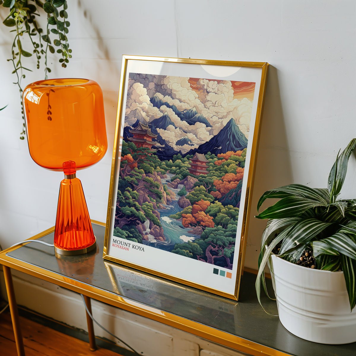 Mount Koya red temple ukiyo-e print shown in a gold frame on a console beside an orange glass lamp