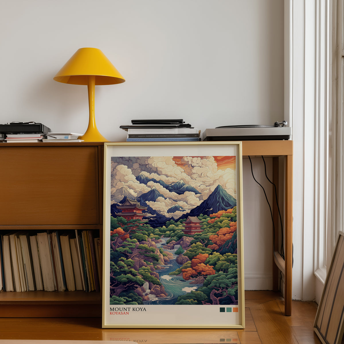 Mount Koya red temple ukiyo-e print shown in a gold frame below a teak desk with a yellow lamp