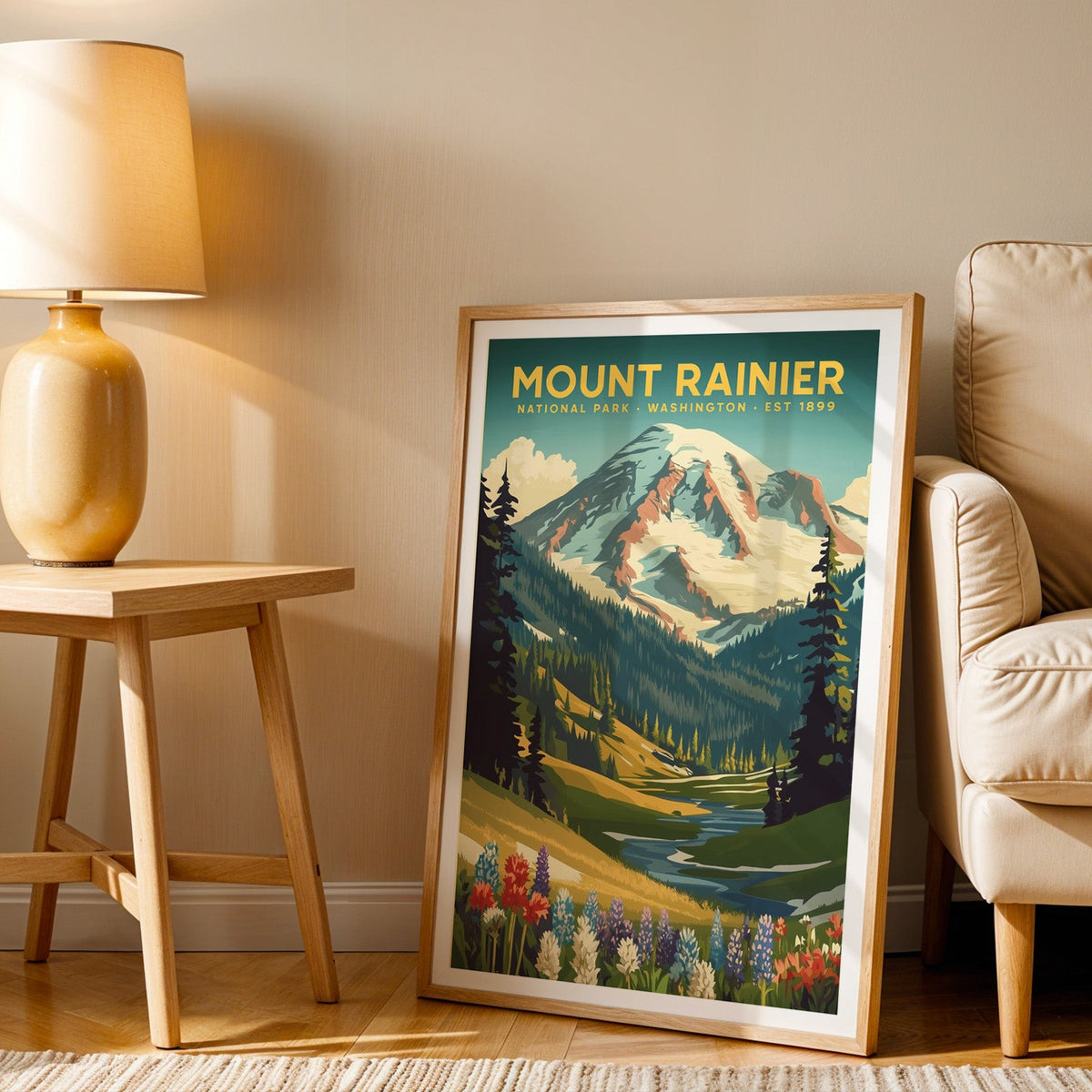 Mount Rainier print in an oak frame beside a cream armchair and an amber lamp in warm afternoon light