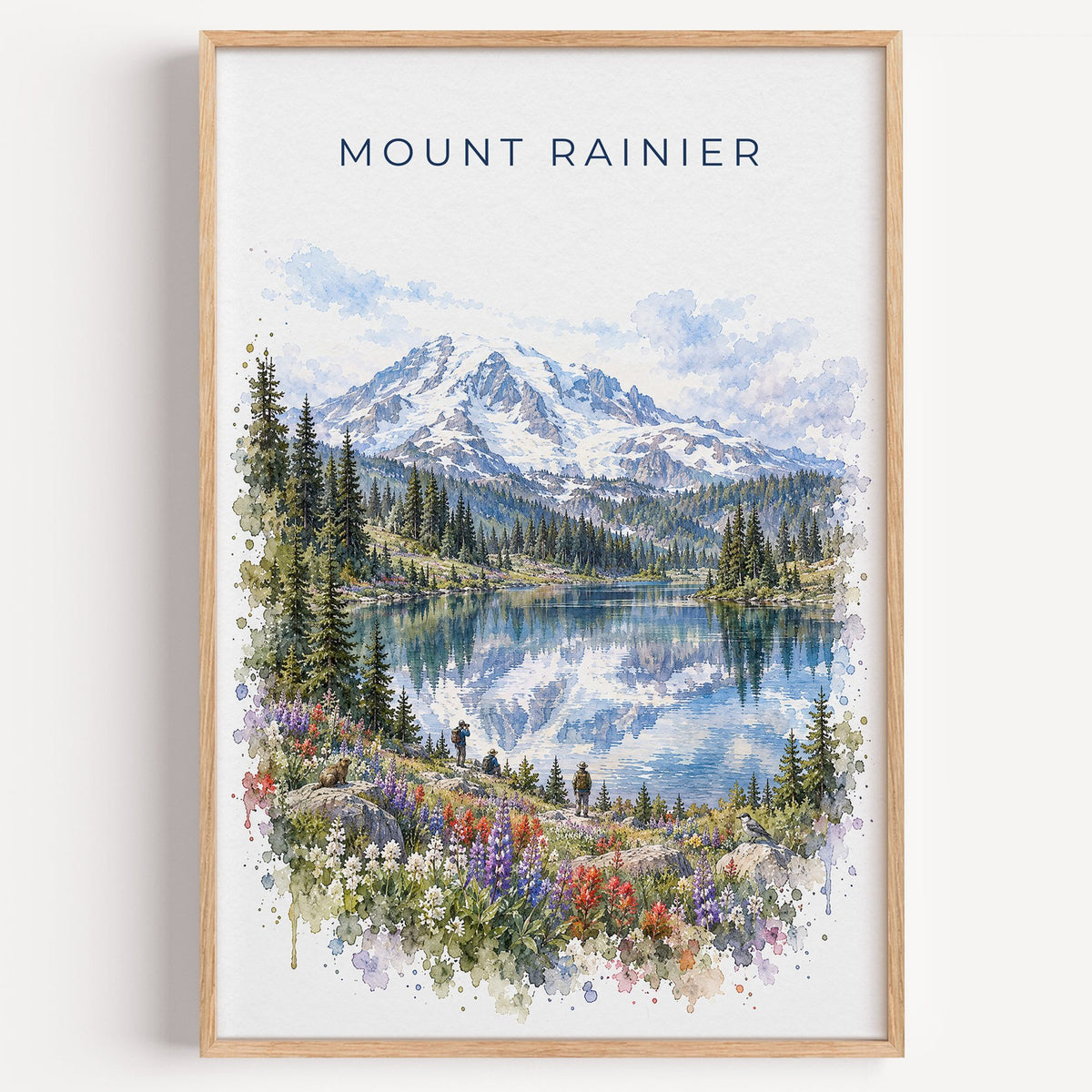 Mount Rainier National Park watercolor print in a light oak frame on a plain white wall