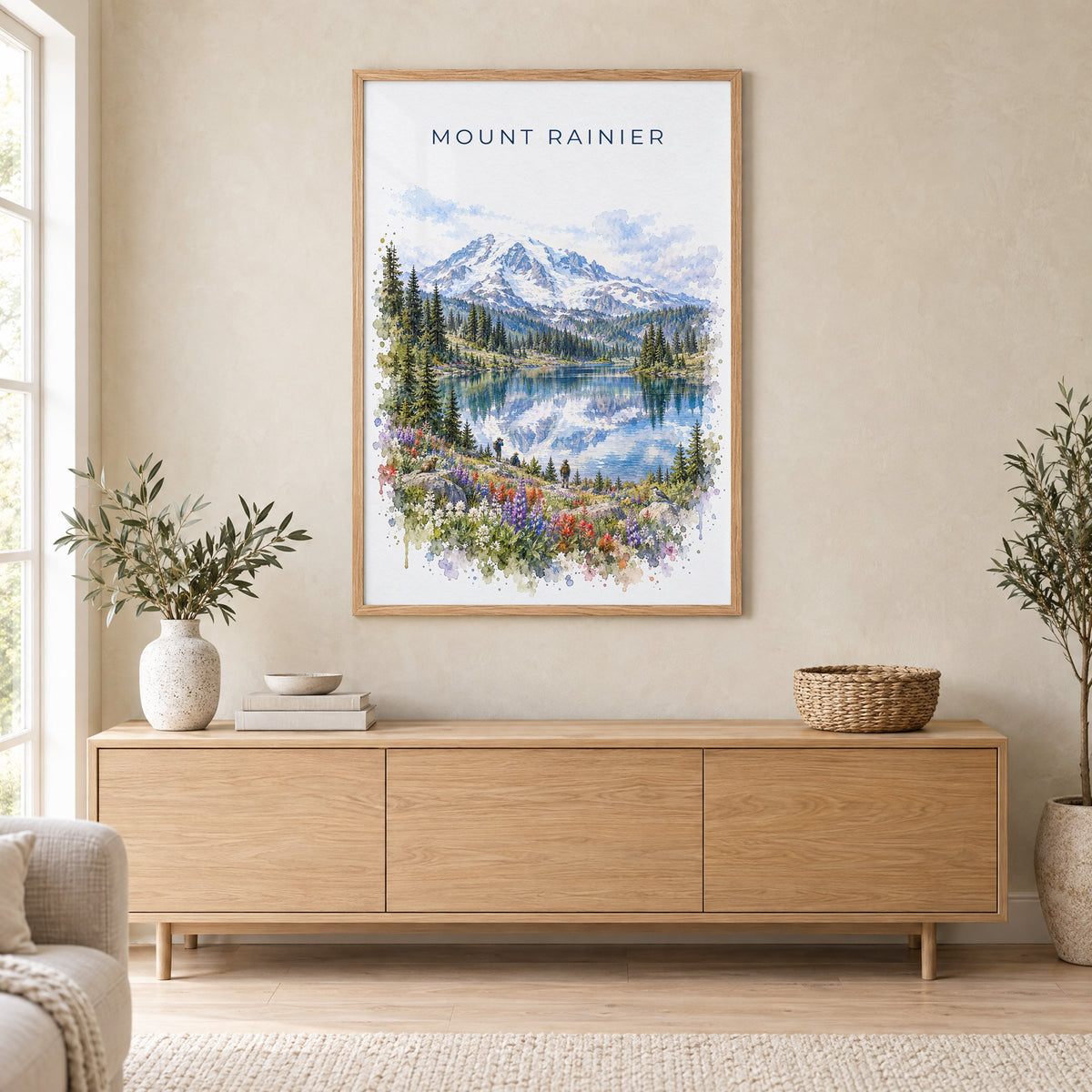 Mount Rainier National Park watercolor print in an oak frame above a light wood sideboard in a Scandinavian living room