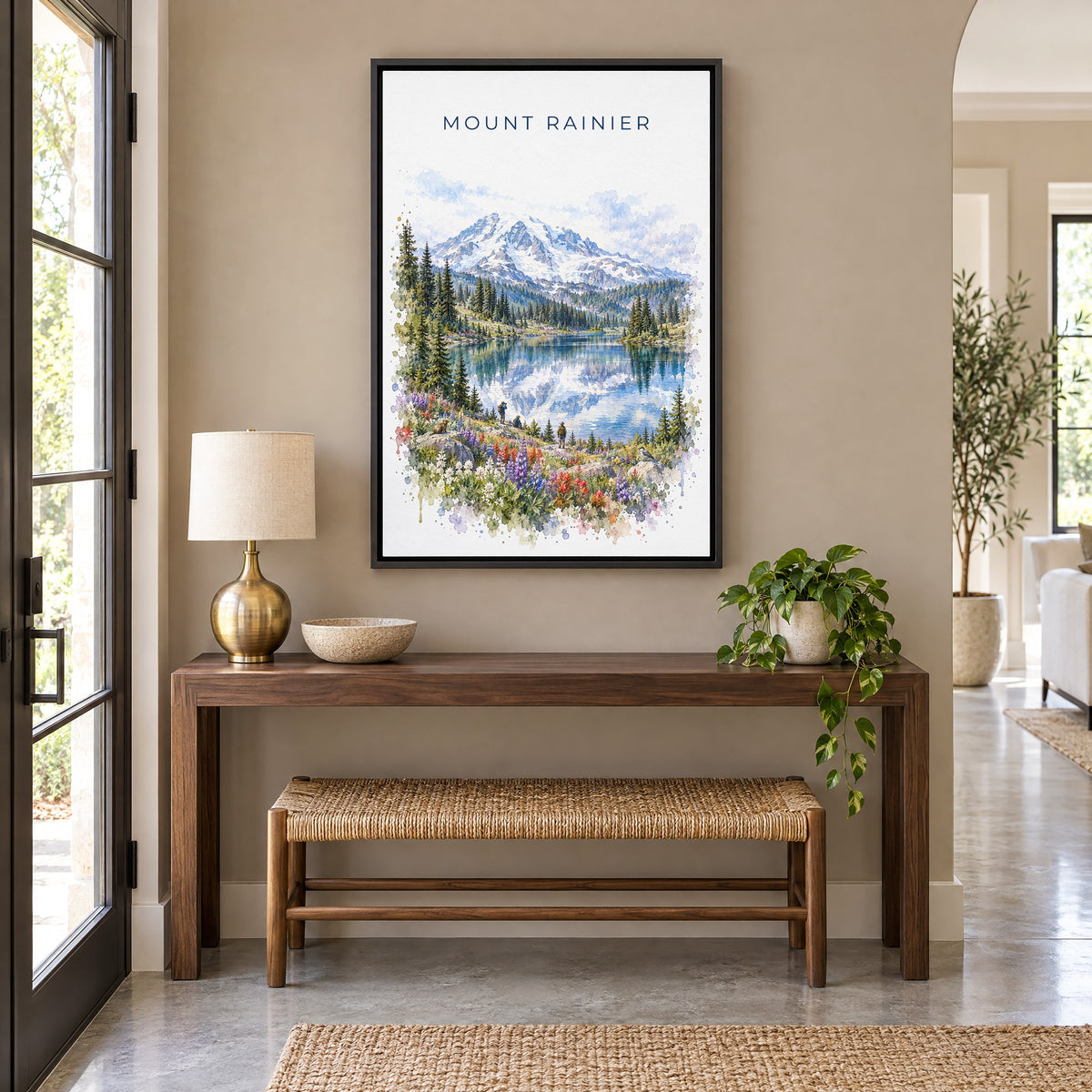 Mount Rainier National Park watercolor print as a black floater canvas above a walnut console and woven bench in an entryway