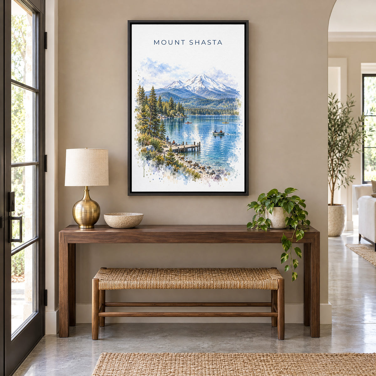 Mount Shasta watercolor print as a black floater canvas above a walnut console and woven bench in an entryway