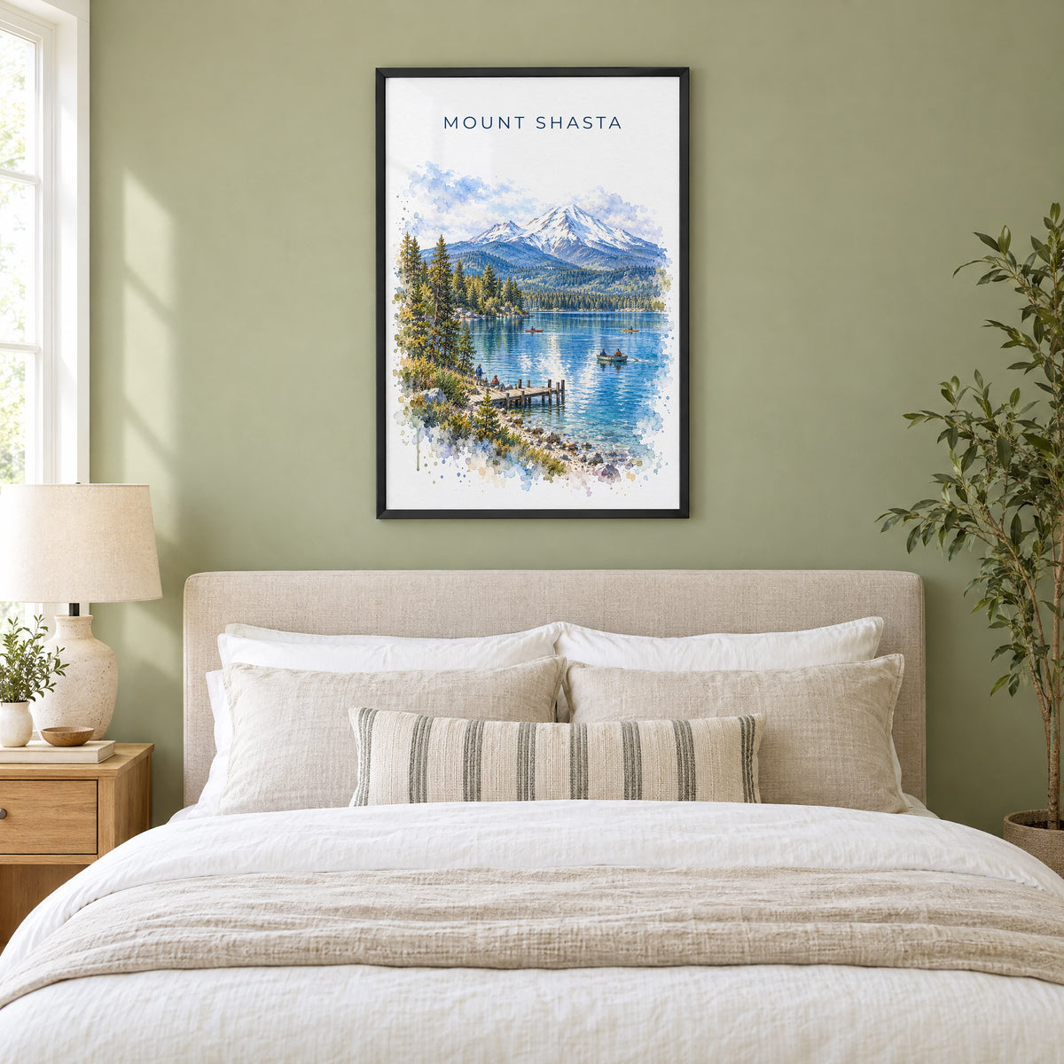 Mount Shasta watercolor print in a black frame above an upholstered headboard in a sage green bedroom