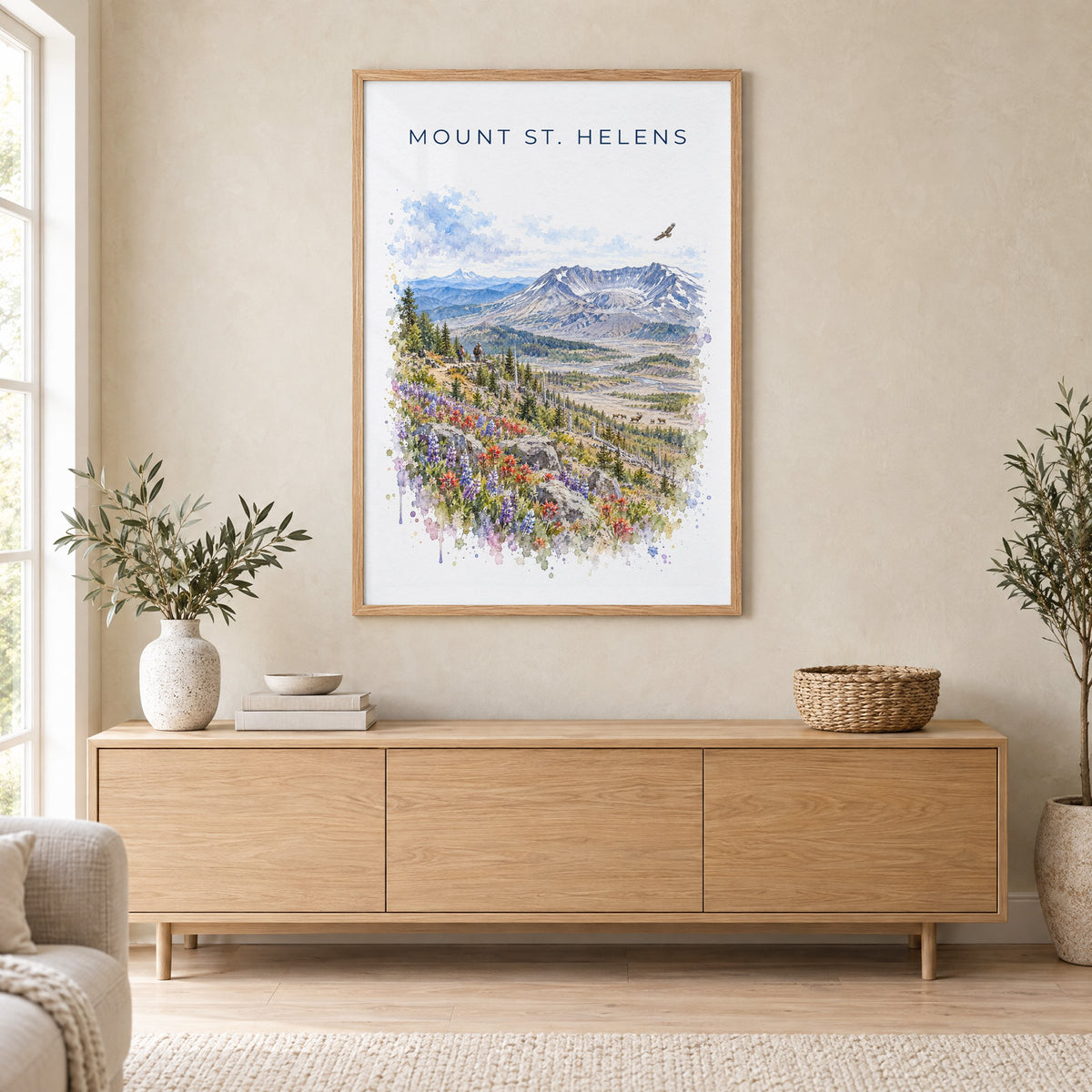 Mount St. Helens watercolor print in an oak frame above a light wood sideboard in a Scandinavian living room