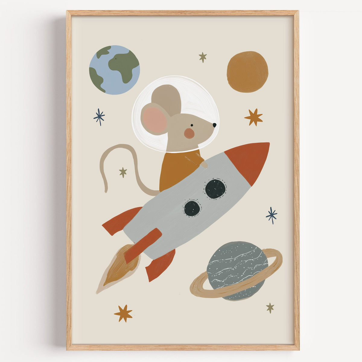 Mouse astronaut riding rocket nursery print in a light oak frame on a plain white wall