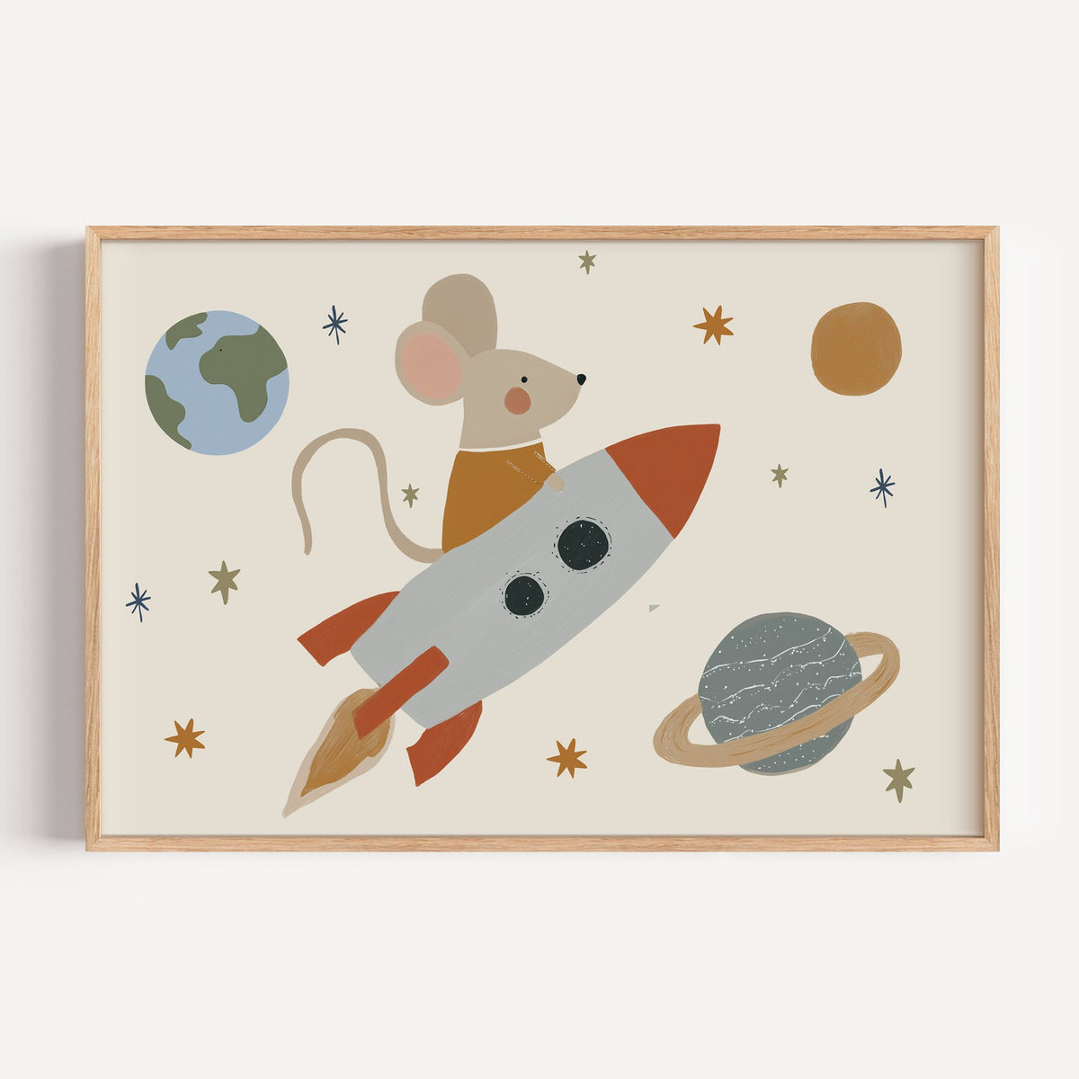 Landscape mouse astronaut riding rocket nursery print in a light oak frame on a plain white wall