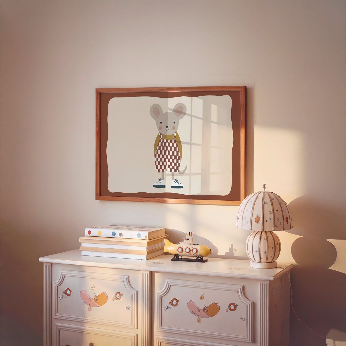 Landscape mouse checkered overalls nursery print in a cherry wood frame above a painted dresser and lamp