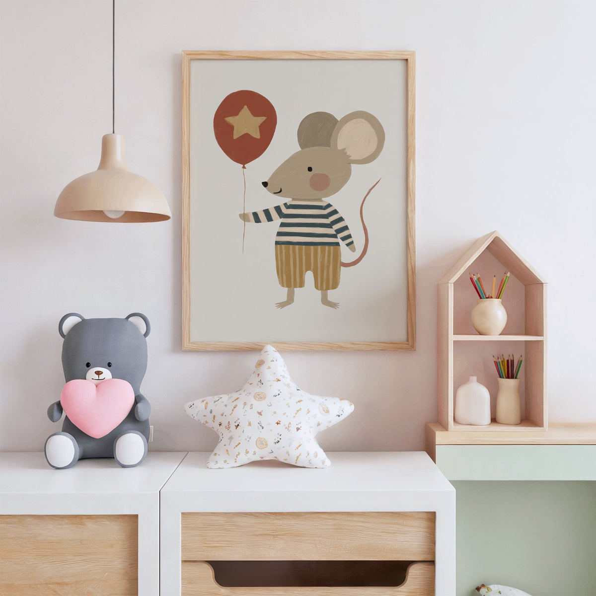 Mouse star balloon striped shirt nursery print in an oak frame above a white dresser with a star pillow and house shelf