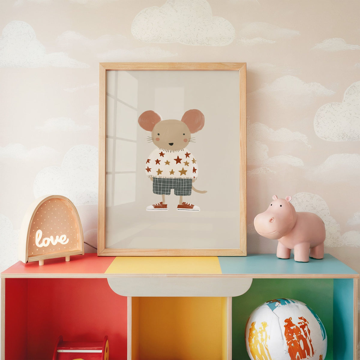 Mouse star sweater plaid shorts nursery print in an oak frame on a rainbow toy shelf against cloud wallpaper