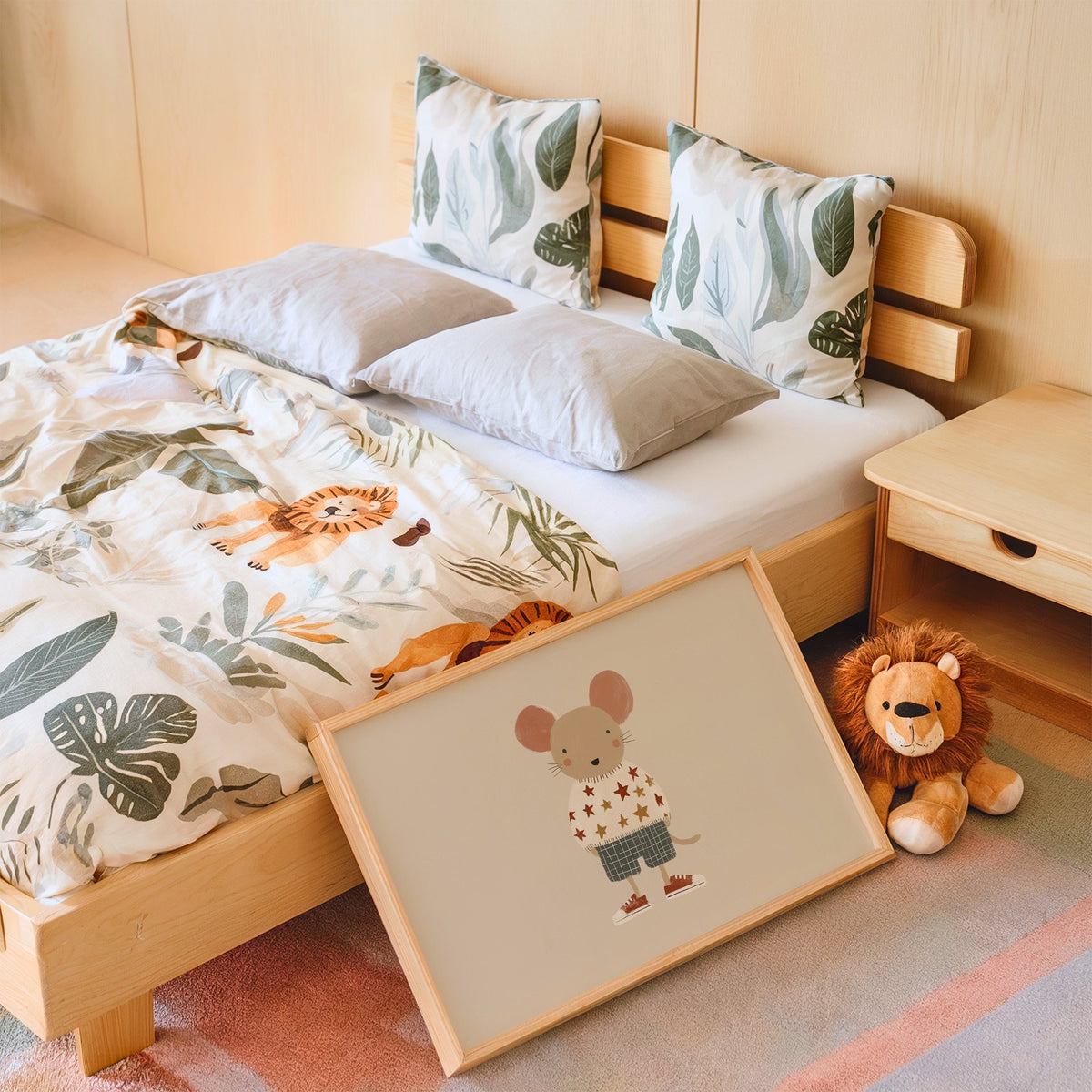 Landscape mouse star sweater plaid shorts nursery print in an oak frame leaning on a kids bed by a lion plush