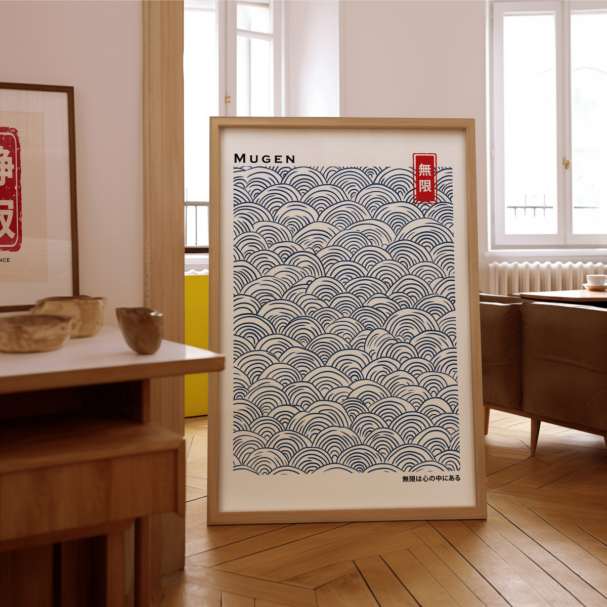 Navy seigaiha wave pattern print in an oak frame on the parquet floor of a sunlit living room