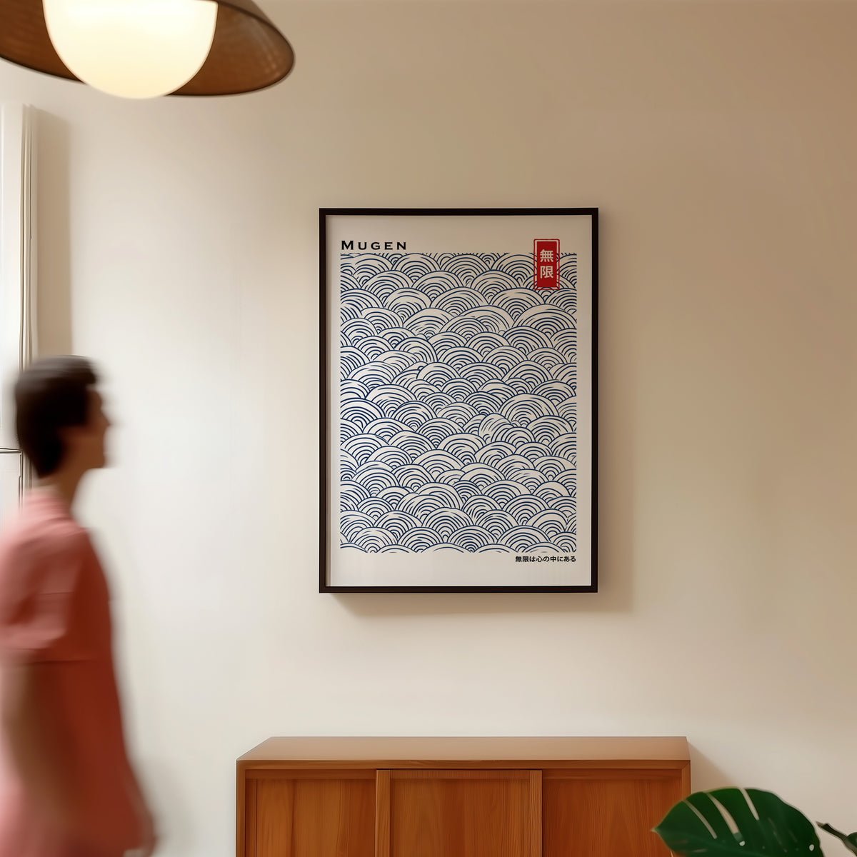 Navy seigaiha wave pattern print in a black frame in a hallway under a rattan pendant