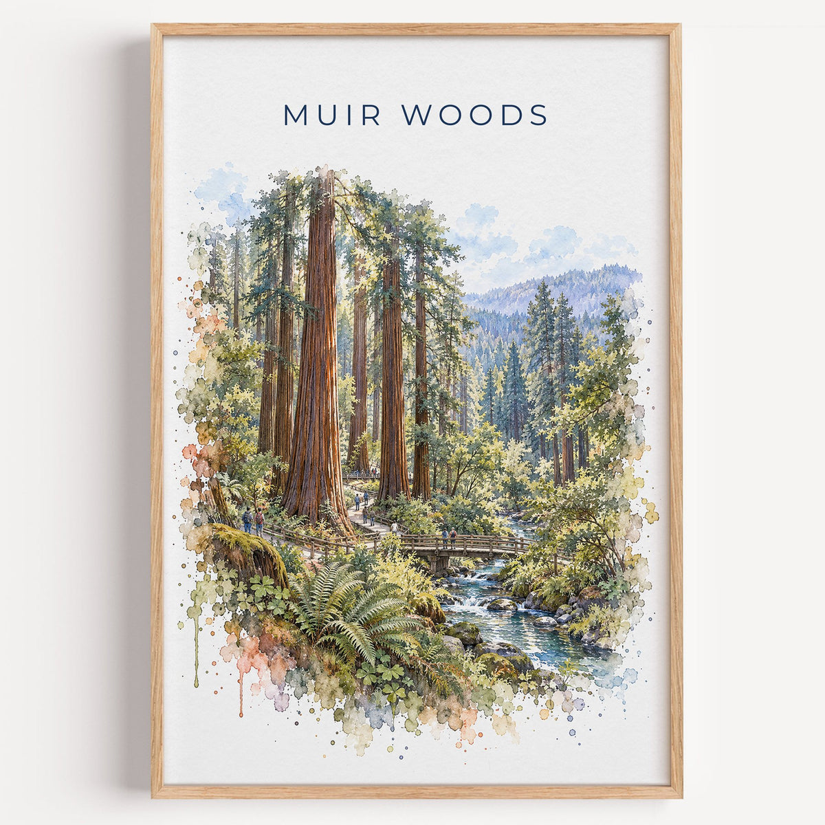 Muir Woods watercolor print in a light oak frame on a plain white wall