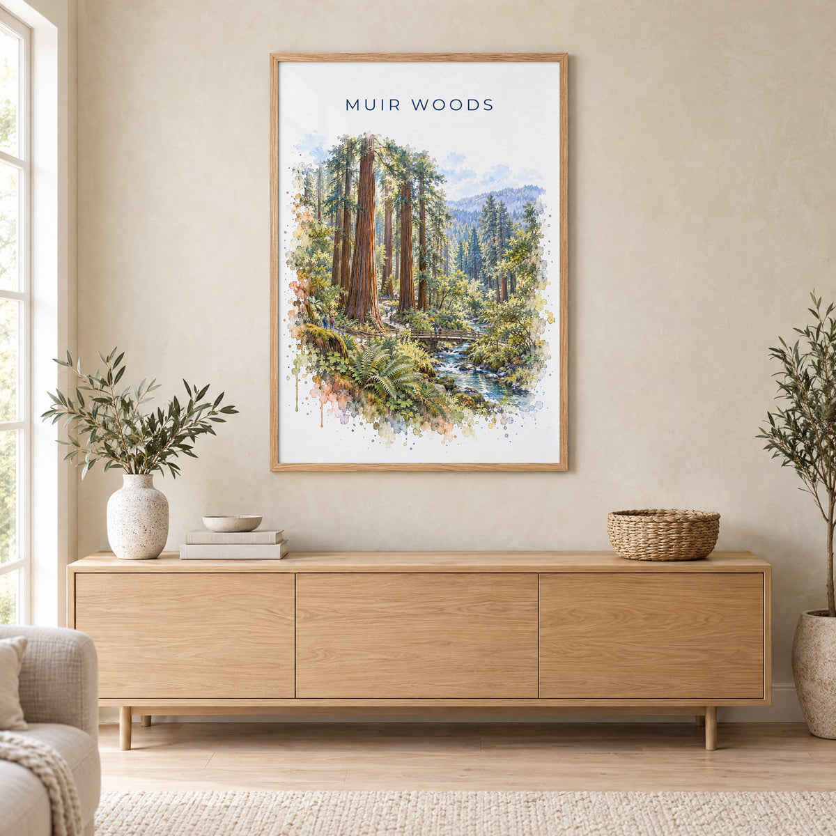 Muir Woods watercolor print in an oak frame above a light wood sideboard in a Scandinavian living room