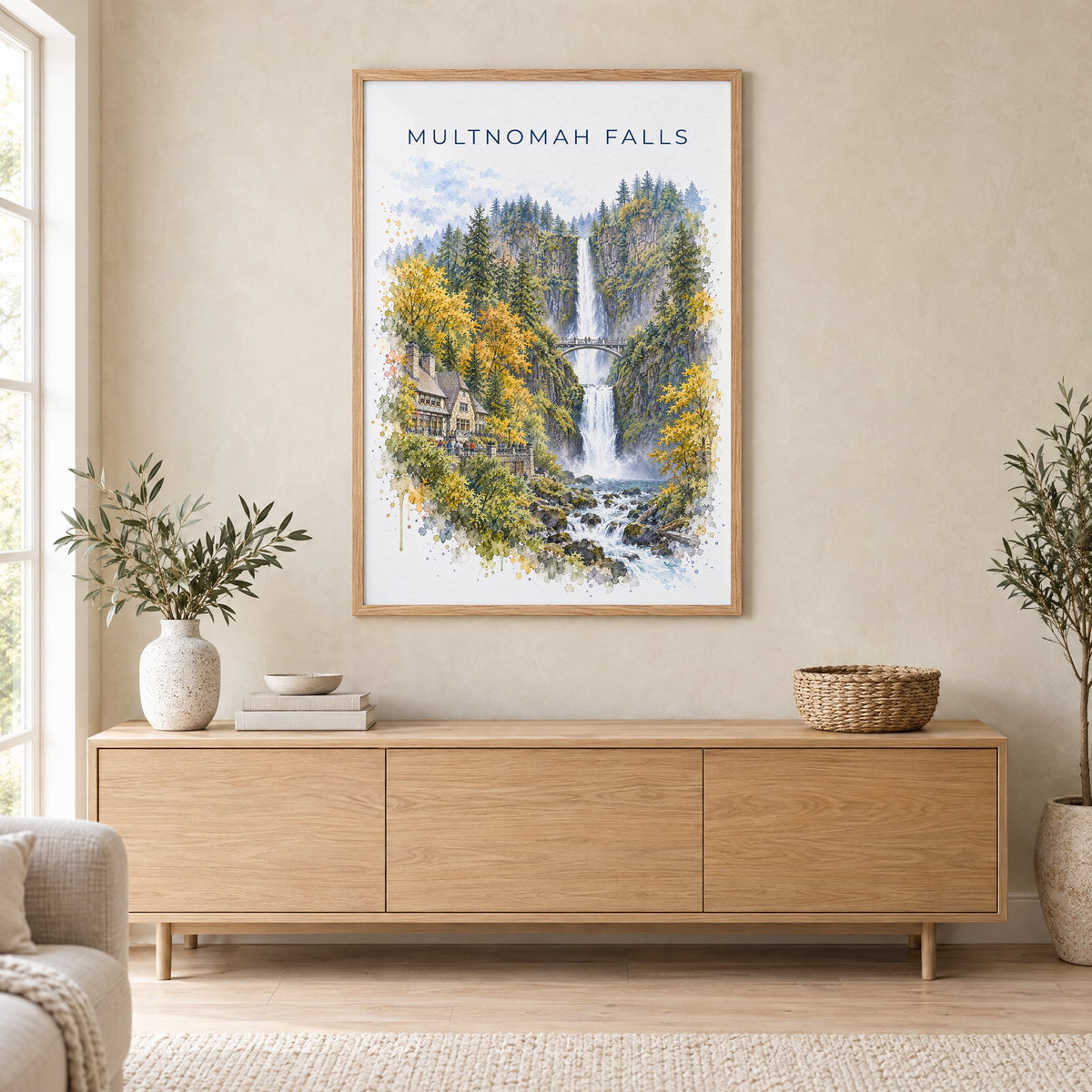 Multnomah Falls watercolor print in an oak frame above a light wood sideboard in a Scandinavian living room