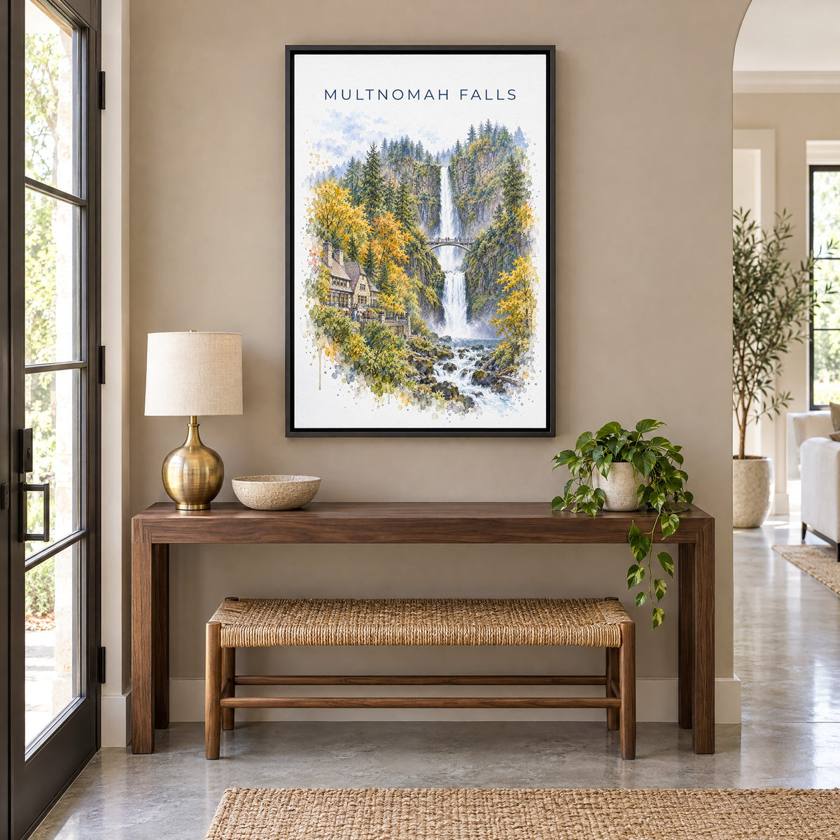 Multnomah Falls watercolor print as a black floater canvas above a walnut console and woven bench in an entryway