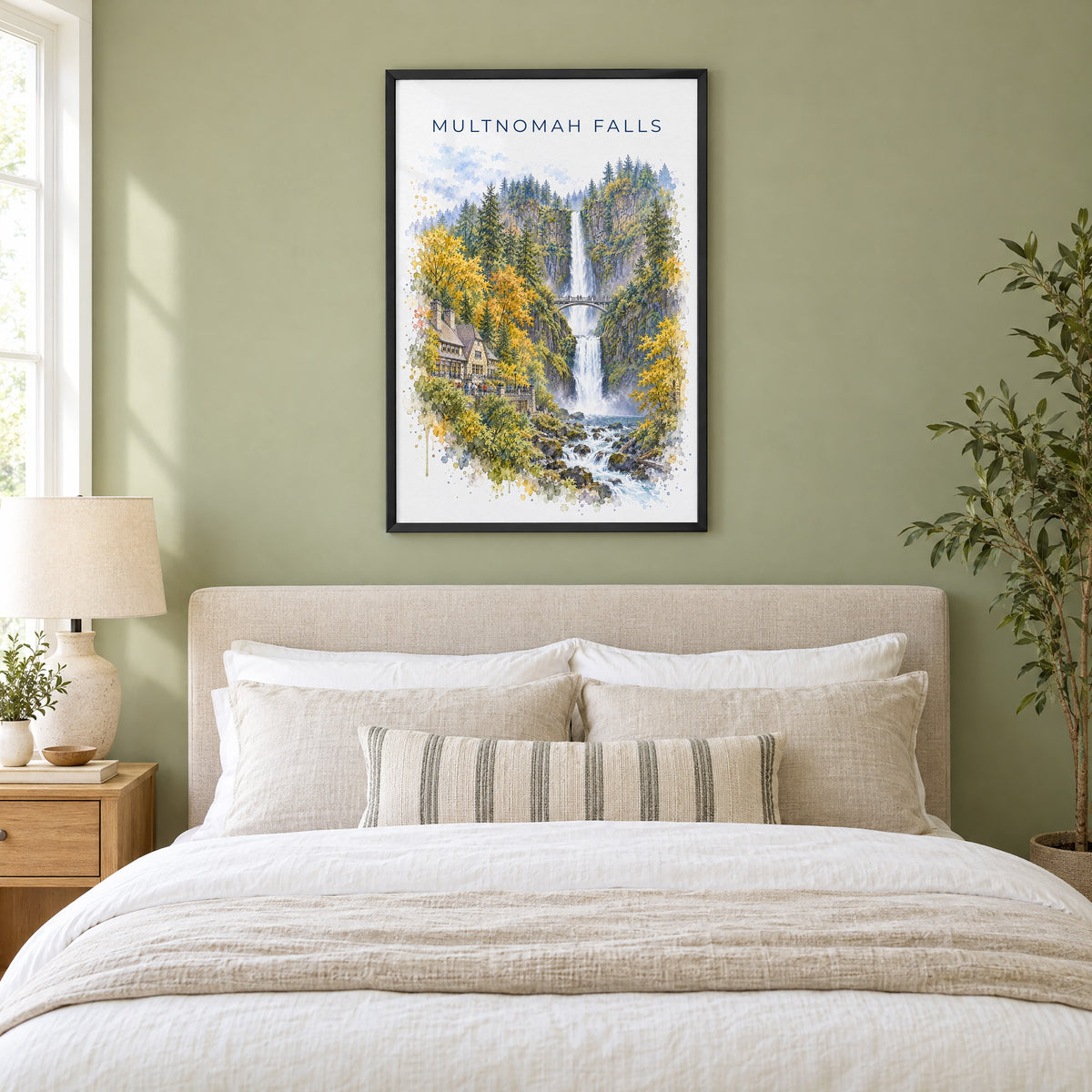 Multnomah Falls watercolor print in a black frame above an upholstered headboard in a sage green bedroom