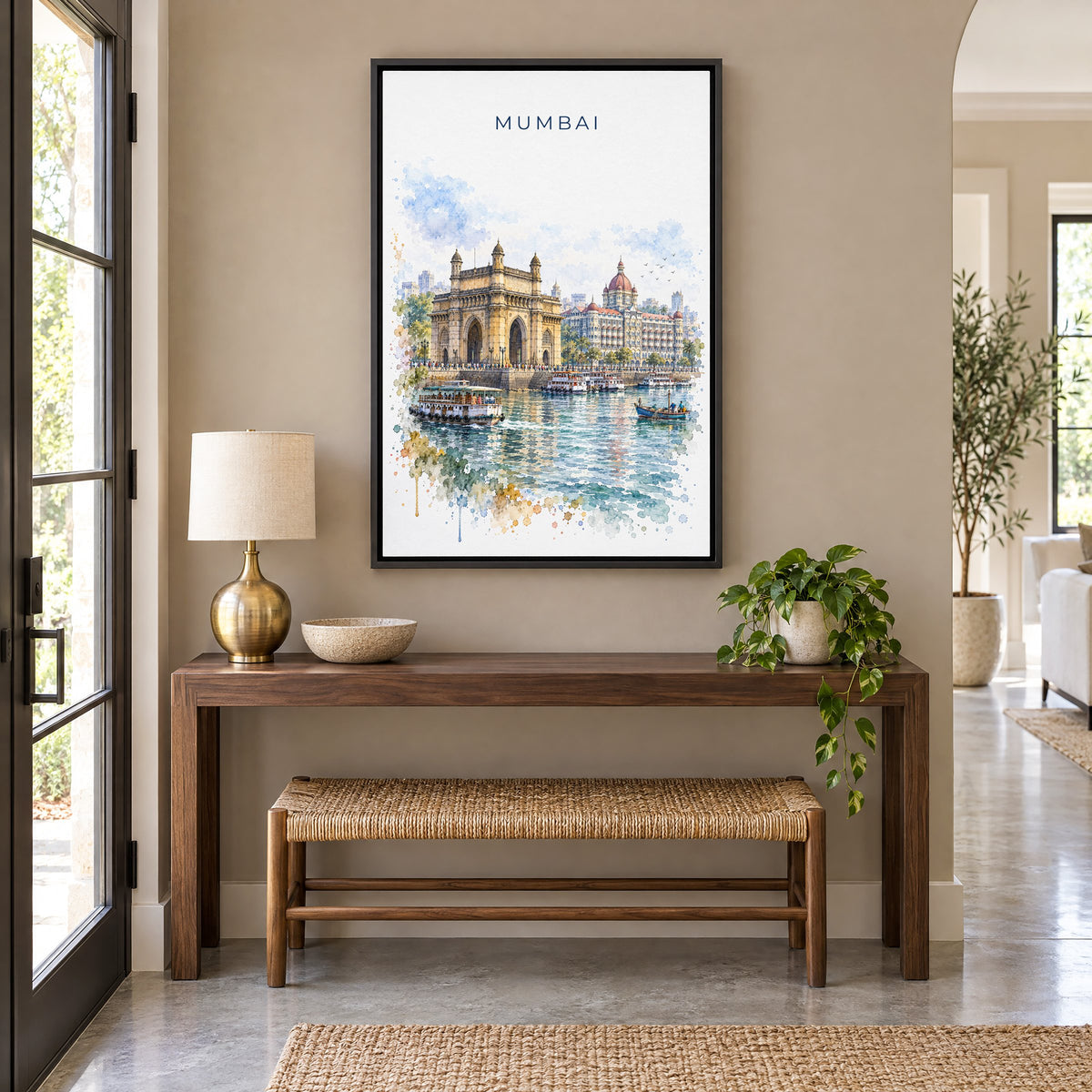 Mumbai watercolor print as a black floater canvas above a walnut console and woven bench in an entryway
