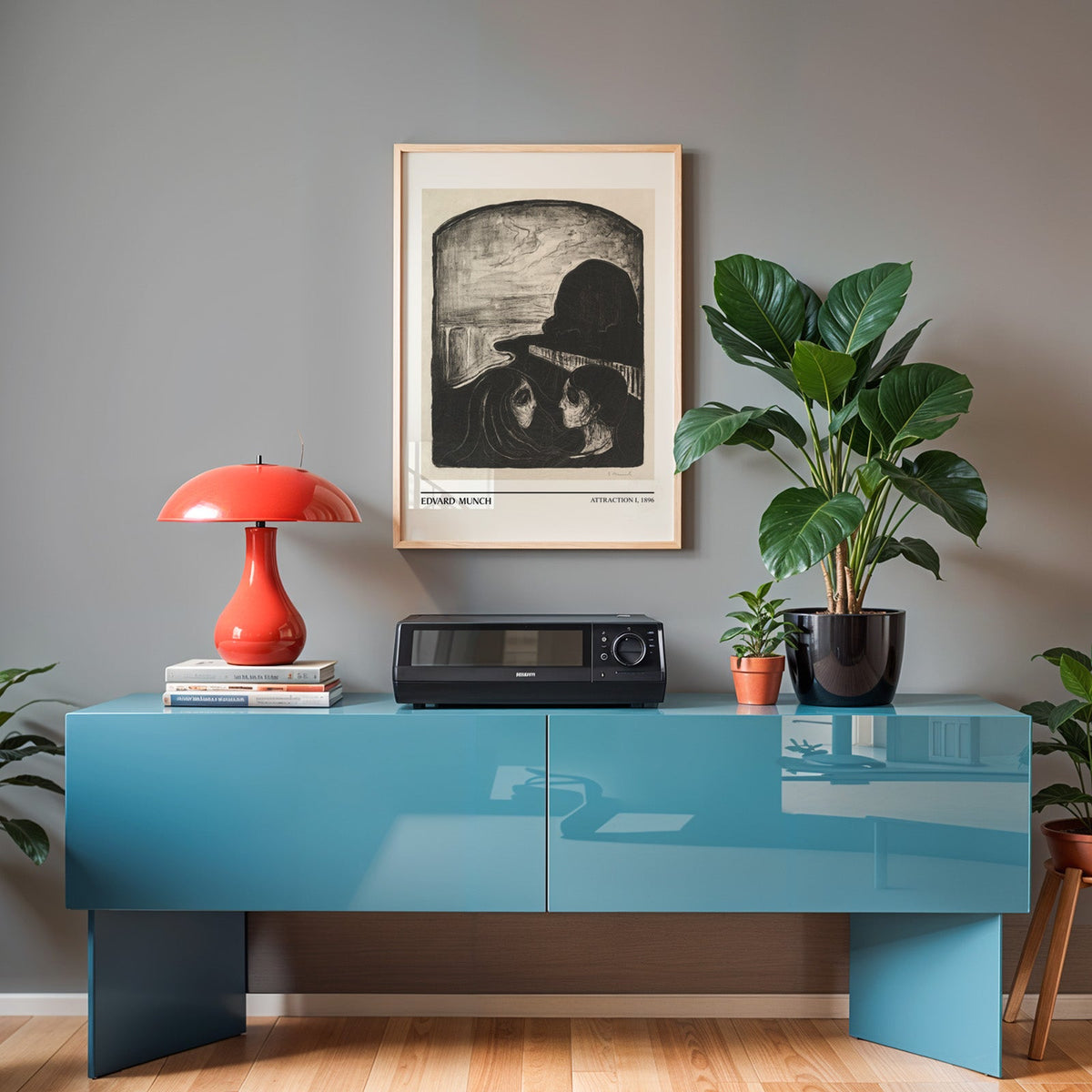 Black and white Munch print in an oak frame above a teal sideboard