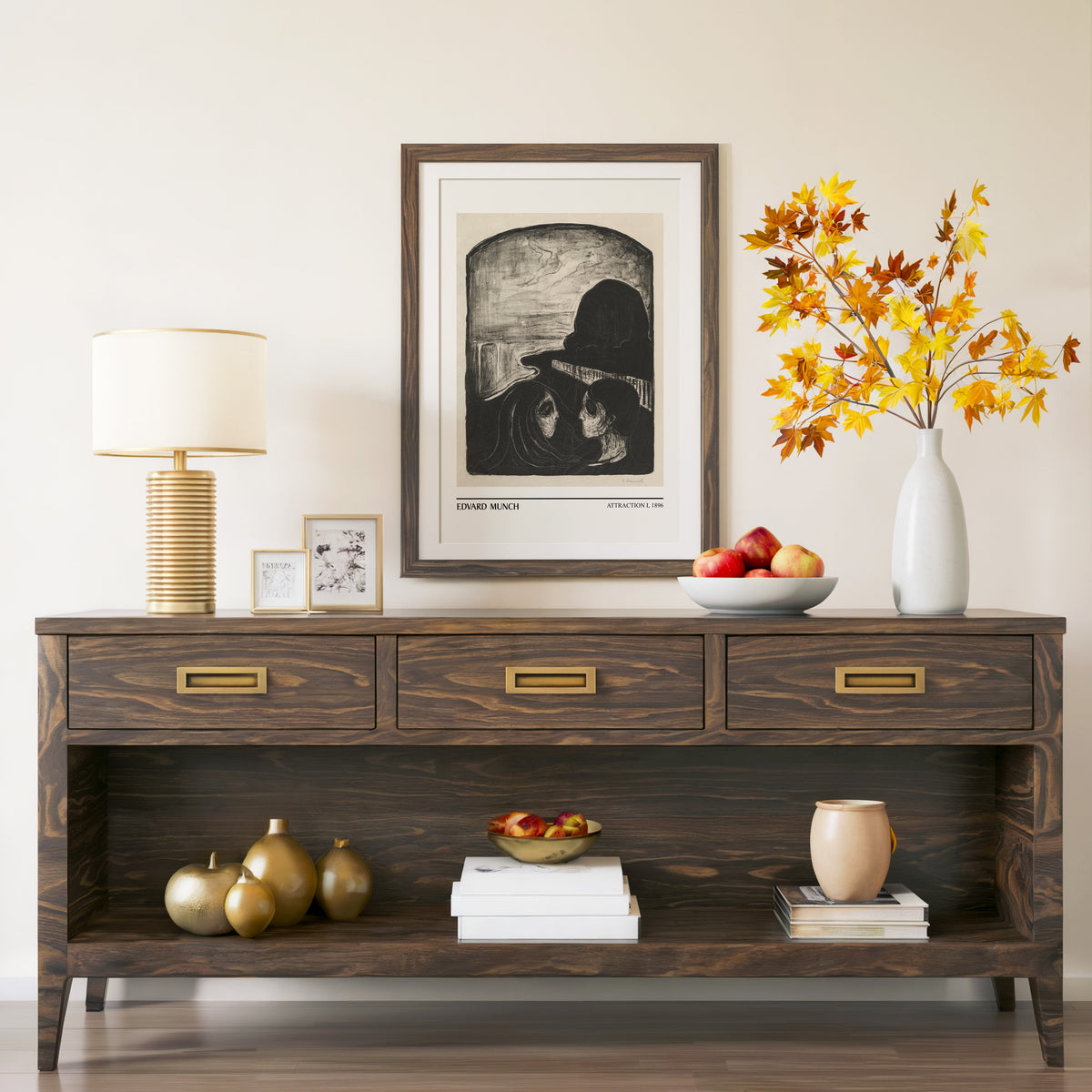 Attraction I print in a walnut frame above a console with autumn branches