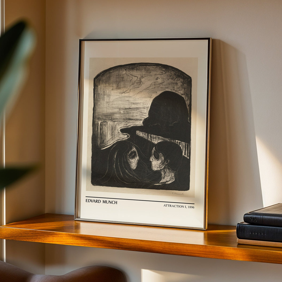 Attraction I print in a black frame on a walnut shelf in warm evening light