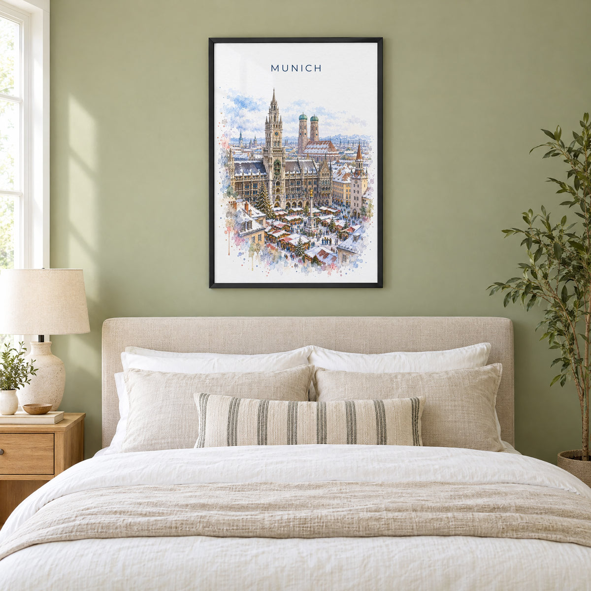 Munich watercolor print in a black frame above an upholstered headboard in a sage green bedroom