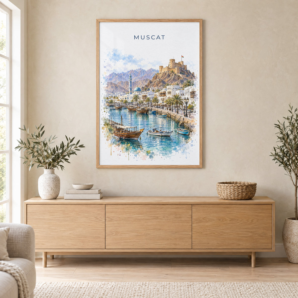 Muscat watercolor print in an oak frame above a light wood sideboard in a Scandinavian living room