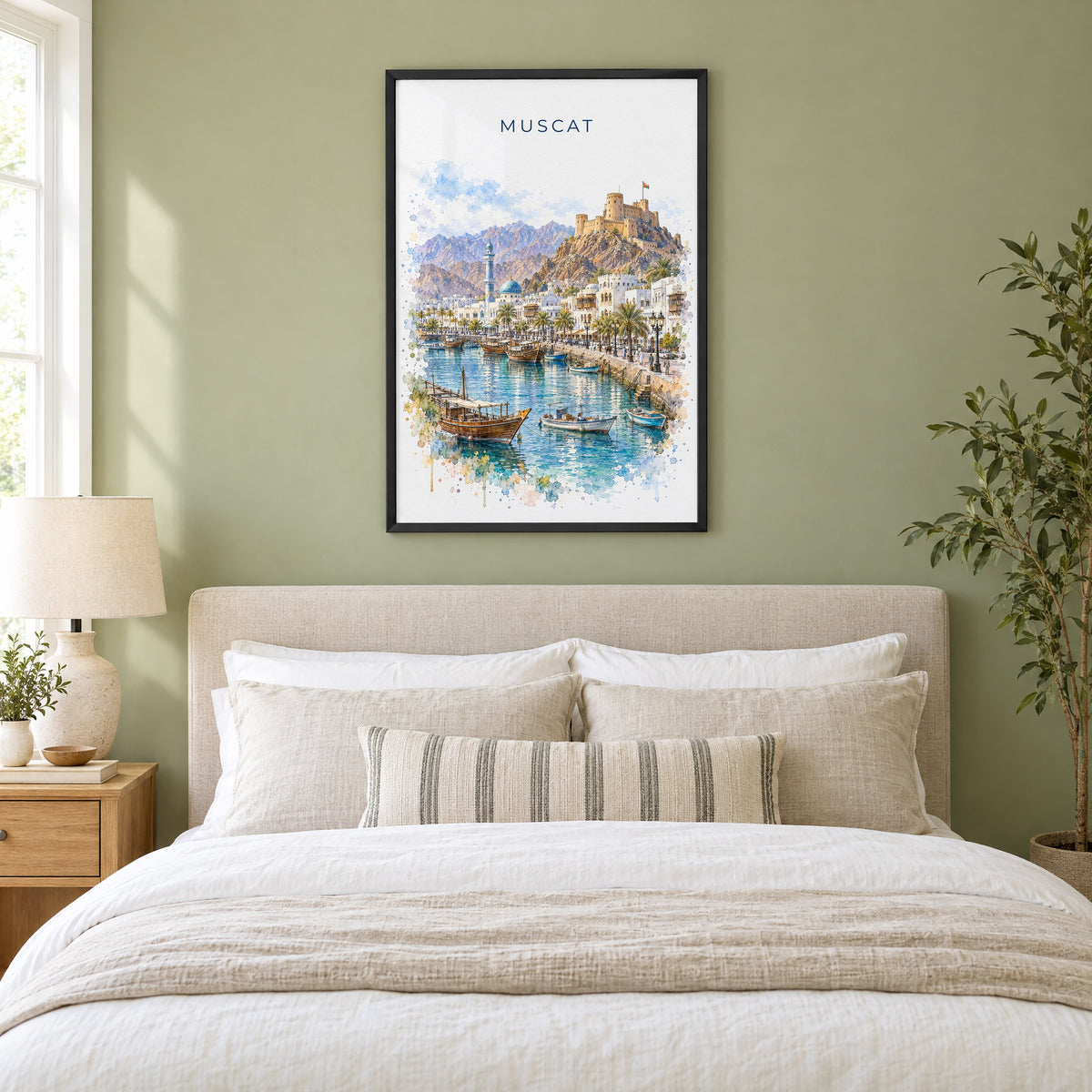 Muscat watercolor print in a black frame above an upholstered headboard in a sage green bedroom