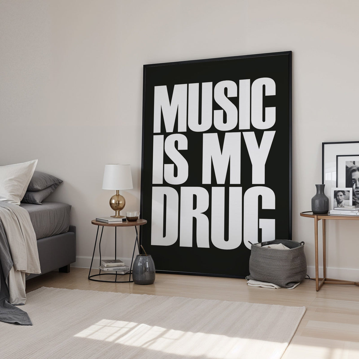 Music Is My Drug white lettering on black print in a black frame leaning in a bedroom beside a gold lamp