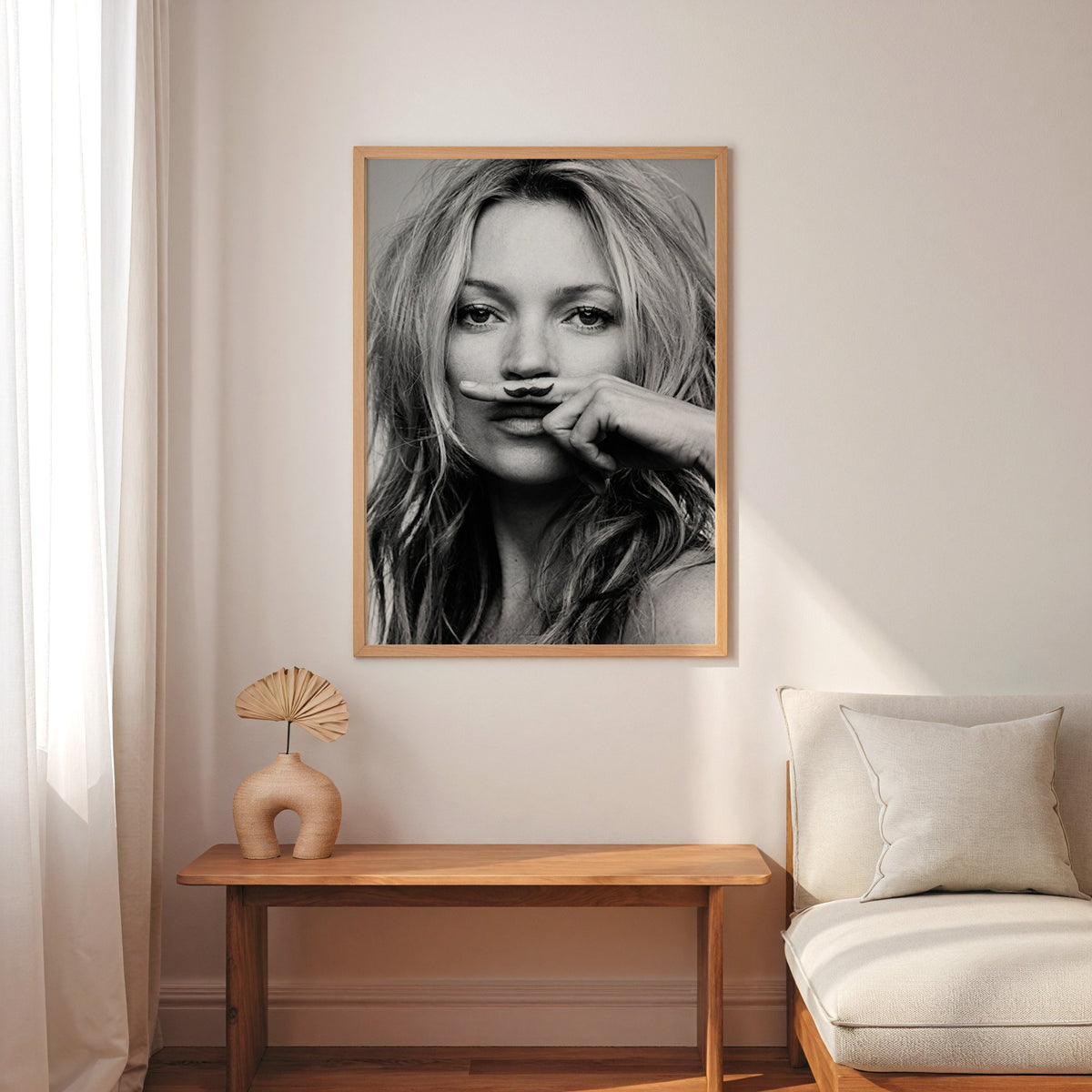 Close portrait with finger mustache under nose print in an oak frame above a narrow console with an arched vase