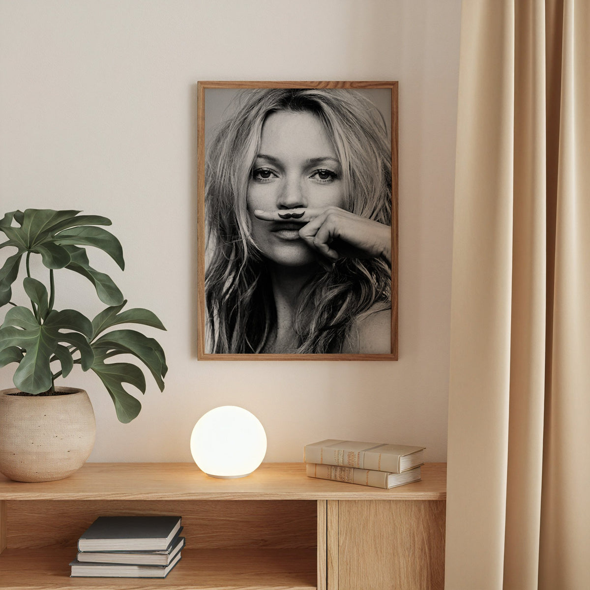 Close portrait with finger mustache under nose print in a walnut frame above an oak cabinet with a glowing globe lamp