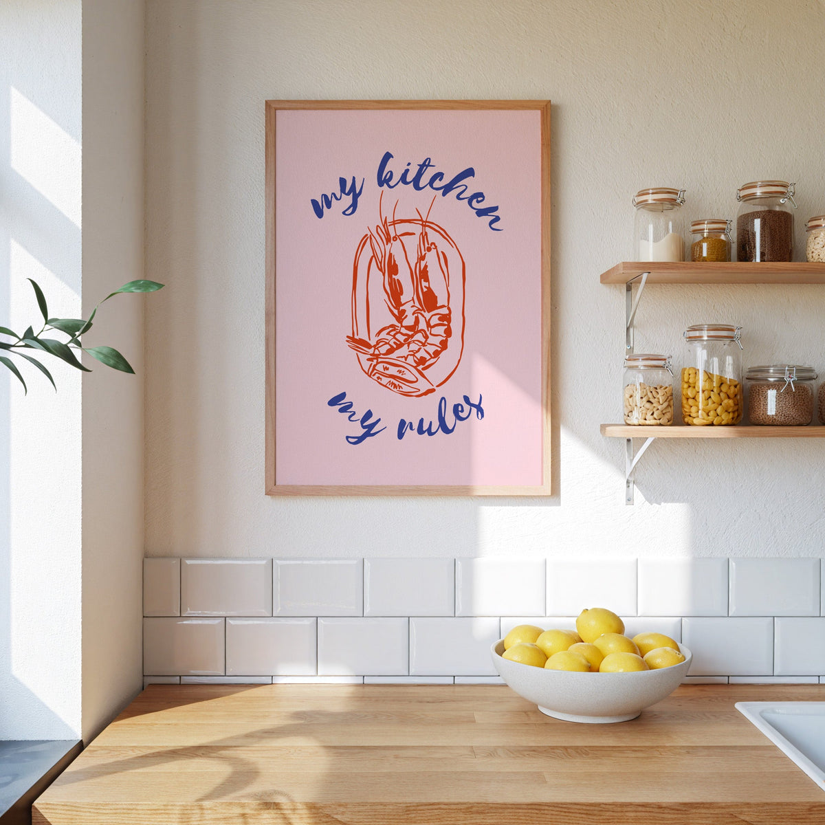 My Kitchen My Rules shrimp print in an oak frame beside open kitchen shelves