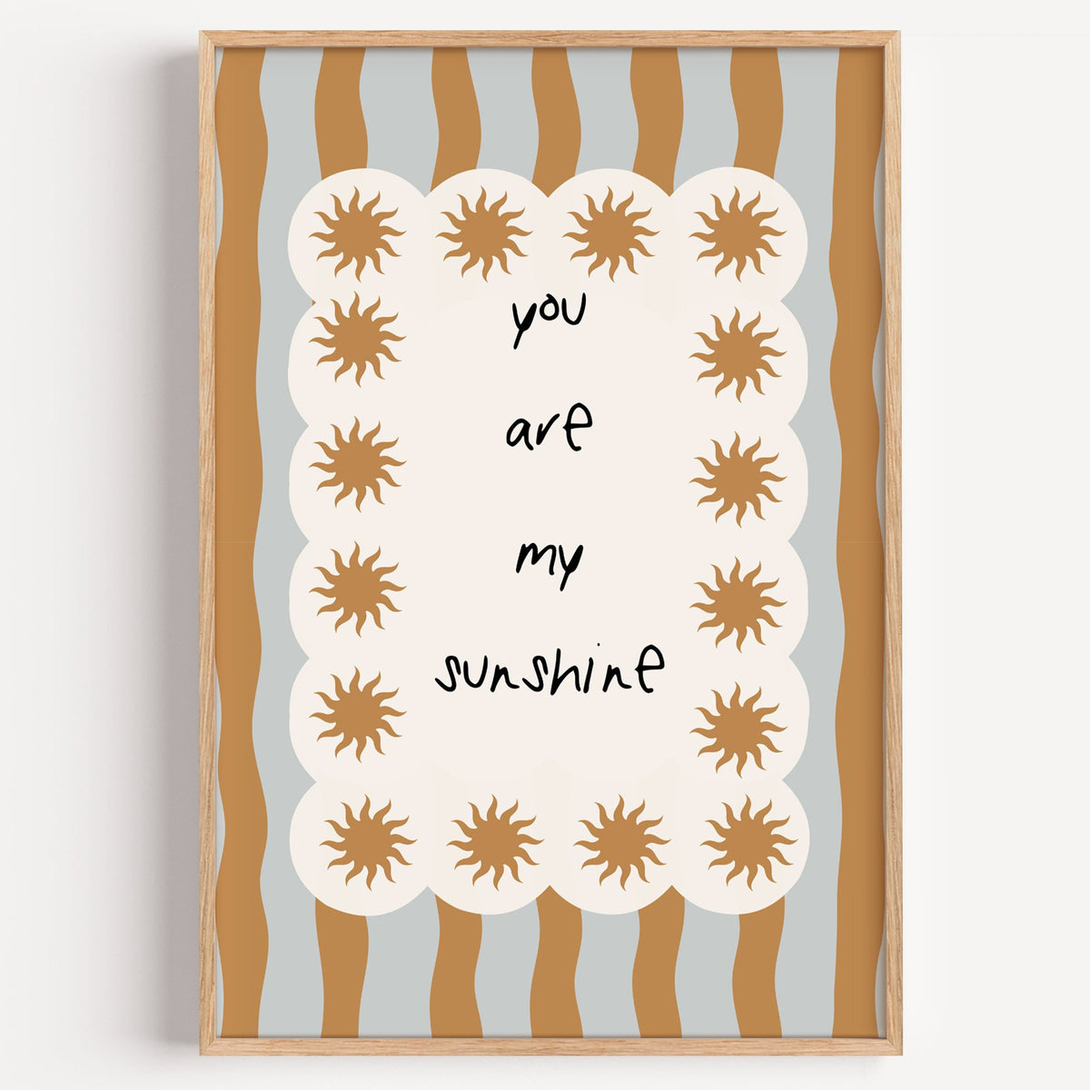 My sunshine sun border nursery print in a light oak frame on a plain white wall