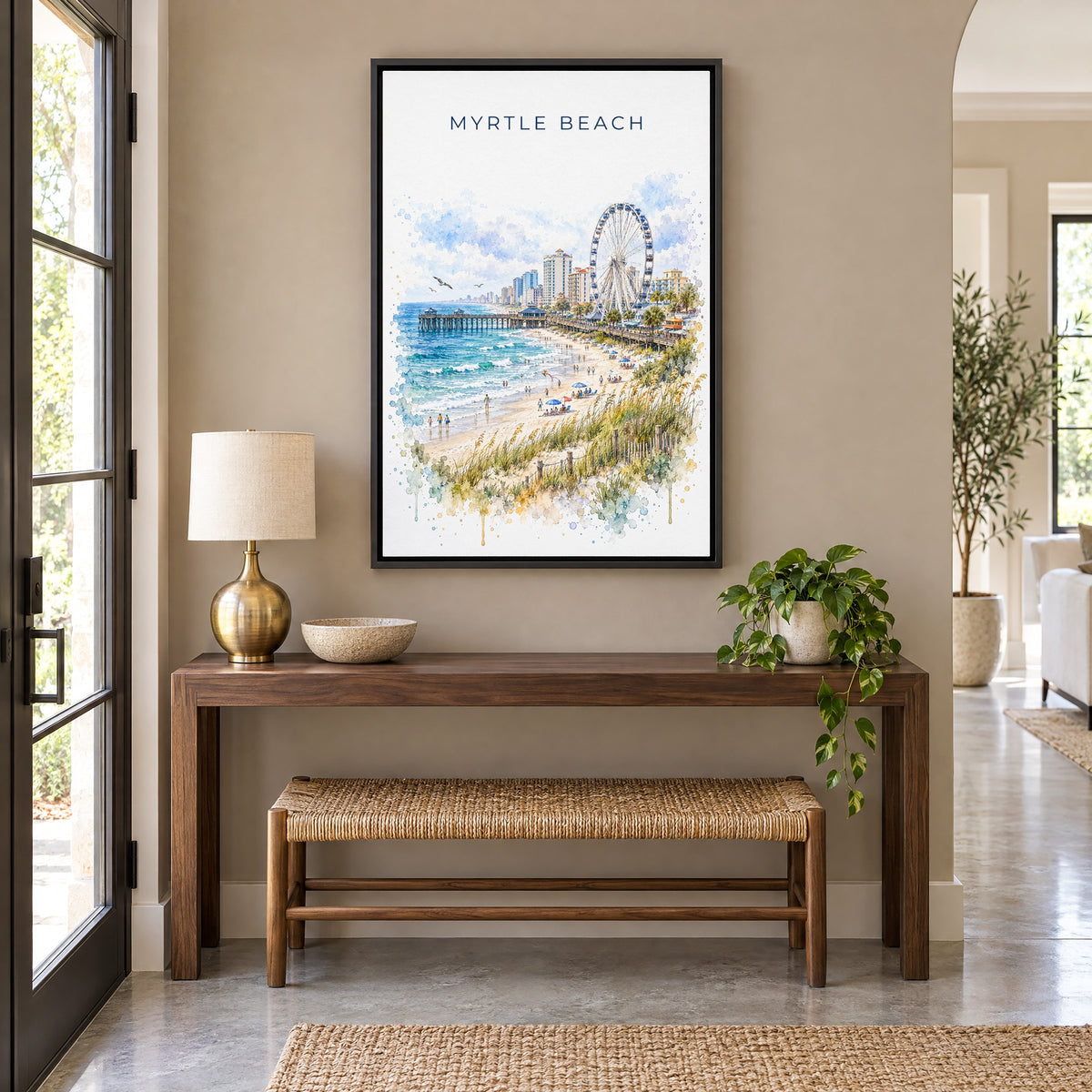 Myrtle Beach watercolor print as a black floater canvas above a walnut console and woven bench in an entryway