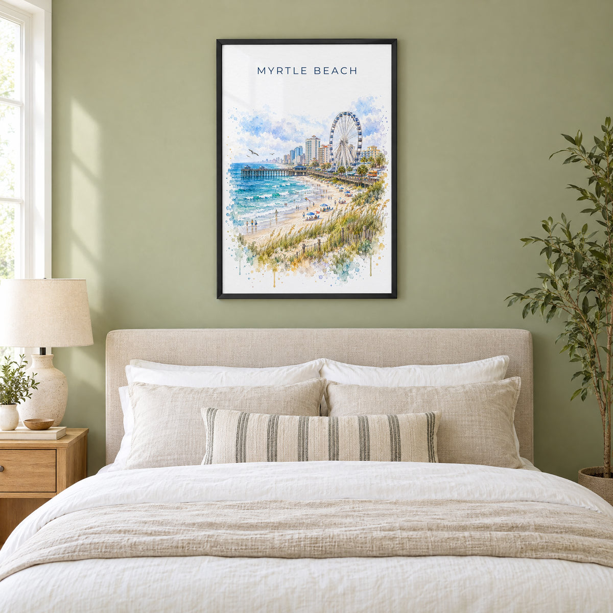 Myrtle Beach watercolor print in a black frame above an upholstered headboard in a sage green bedroom