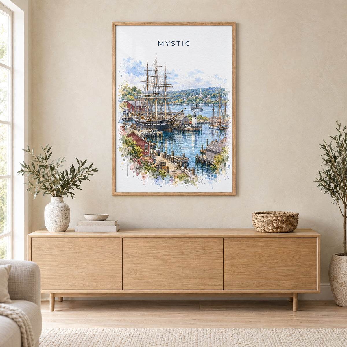 Mystic, Connecticut watercolor print in an oak frame above a light wood sideboard in a Scandinavian living room