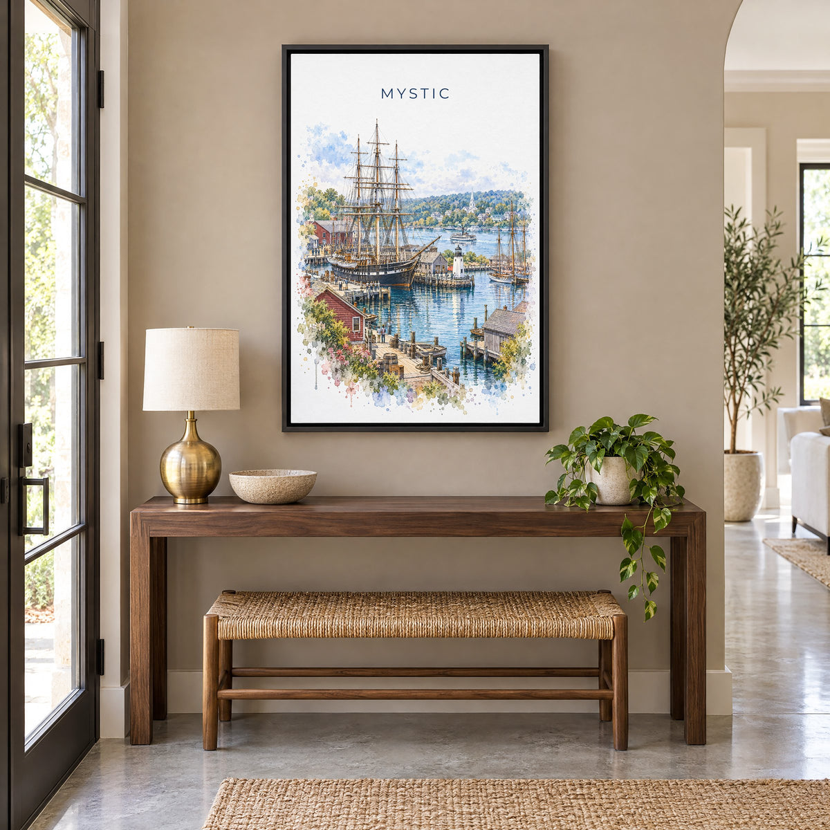 Mystic, Connecticut watercolor print as a black floater canvas above a walnut console and woven bench in an entryway