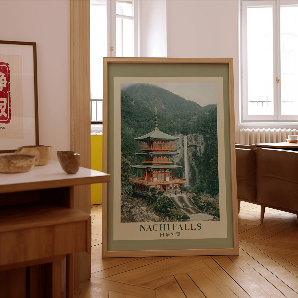 Nachi Falls and red pagoda print in an oak frame on the parquet floor of a sunlit living room