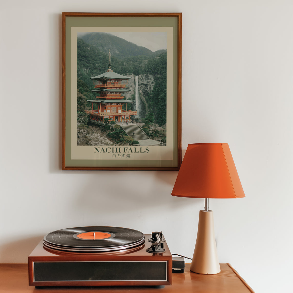 Nachi Falls and red pagoda print in a walnut frame above a sideboard with a record player